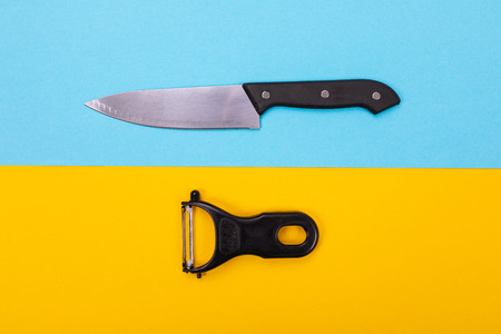 Composition of kitchen utensils for cooking isolated on colorful blue-yellow backgroundの写真素材