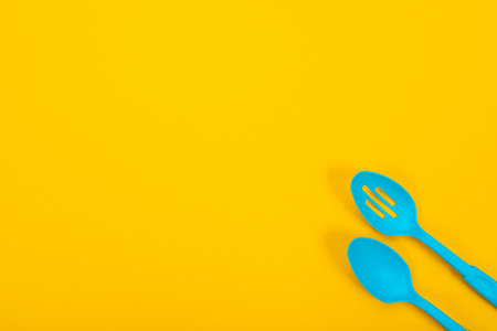 Composition of kitchen utensils for cooking isolated on colorful yellow backgroundの写真素材