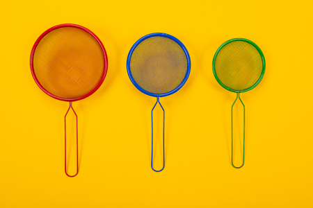 Composition of kitchen utensils for cooking isolated on colorful yellow backgroundの写真素材