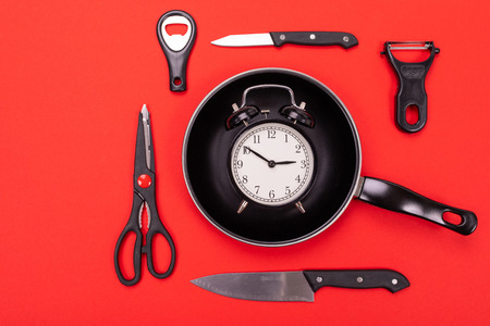 Close up picture of group of kitchen utensils with copyspace on red backgroundの写真素材