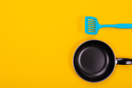 Stylish kitchen tools isolated close - up on a yellow tablecloth. Place for writing. The concept of kitchen supplyの写真素材