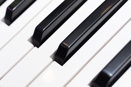 Close-up of Piano Keyboard centred on Ab with plenty of white space. Piano keys. close frontal view. MIDI keyboard with pads and fadersの写真素材