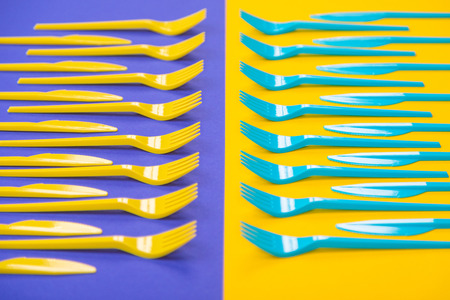 Composition of colorful kitchen cutlery on a bright background top view