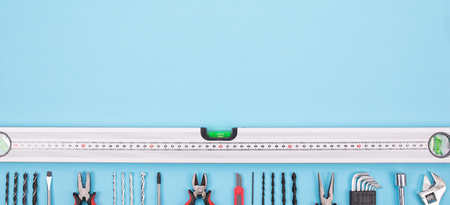 Set of different tools on blue background are spread out in a row