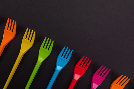 Composition of colorful plastic forks on a bright background top viewの写真素材