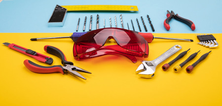 different metalwork kits with red goggles on blue backgroundの写真素材