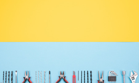 Set of different tools on blue background are spread out in a rowの写真素材