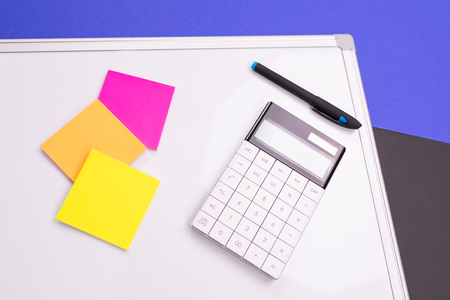 Top view of work place with modern accounting supplies isolated on blue black backgroundの写真素材