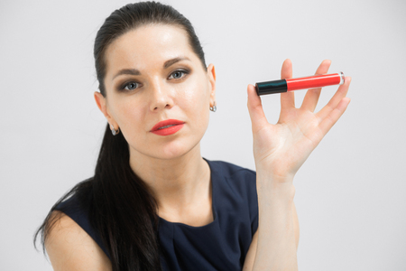 portrait of make up artist adult blonde woman with cosmetic in hands on background. Female fashion conceptの写真素材
