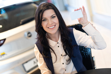 Portrait of stylish insurance agent holding a card. Copy-spaceの写真素材