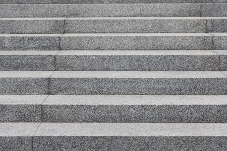Straight view of grey cobblestone steps, background with grunge texture