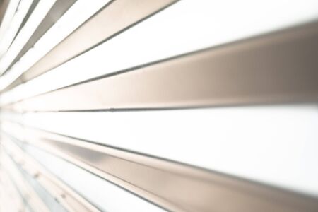 Blurry striped wall with sunlight shining through it