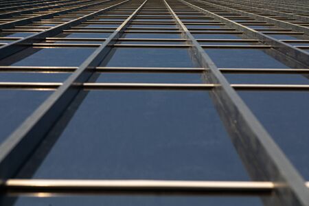 Bottom view of mirrorlike office building wall
