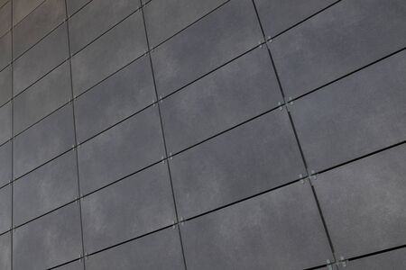 Diagonal view of smooth gray rectangular tile on wall, for background or design.の写真素材