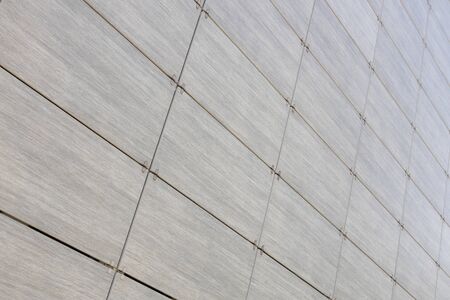 Textured pattern on gray rectangular tiles with dark space in between, diagonal view