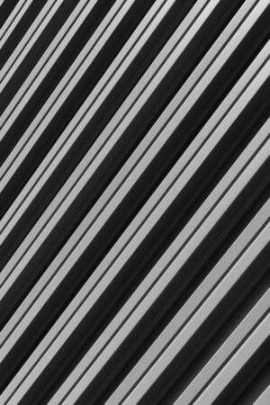 Vertical diagonal view of gray corrugated metal building facadeの写真素材