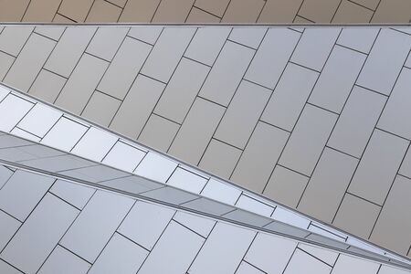 Close-up of geometrically designed building with white tiled walls and triangular protrusions