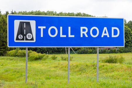 Roadsign Toll road against sky and fieldの写真素材