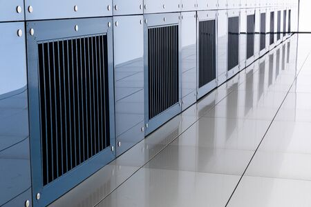 Diagonal view of ventilation grit in modern apartment building with blue wall.
