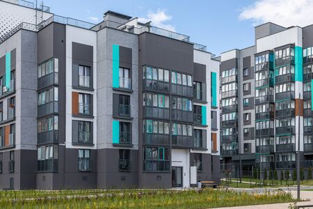 Minsk, Belarus - May 2019. Freshly painted in grey and mint colors block of flats in dormitory...