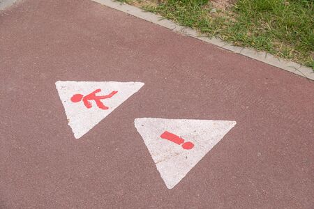 Road marking Beware Children Playing with exclamation mark on asphalt