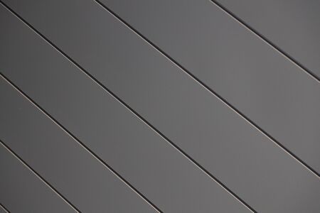 Close-up of smooth matte clean grey siding wall