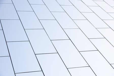 Wide angle view of white smooth matte wall of geometrically designed building. Photo with depth of...