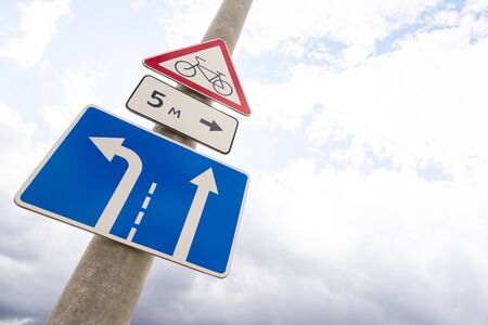 Bottom view of warning roadsign Bikeway with direction tablet and blue tablet with traffic allowed...