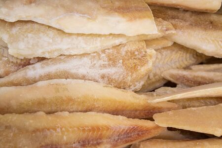 Many frozen fish fillets background at fish market.