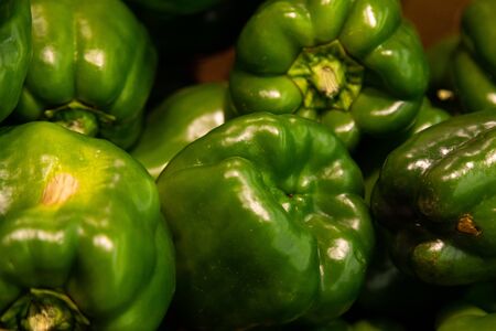 Close-up of fresh sweet pepper of green color in carton box on supermarket counter. Photo with depth of fieldの写真素材