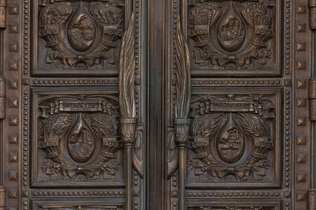 Minsk, Belarus - June 2019. Wooden door with carving of memorials of Chernobyl nuclear explosion and death campsのeditorial素材