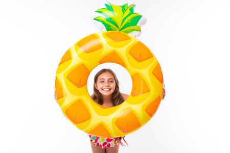 beautiful child on vacation by the sea, beach season with a charming girl with a smile on her faceの写真素材