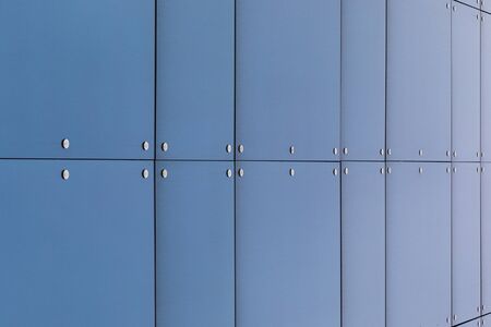 Front view of smooth blue panel on business centre facade, exterior design.