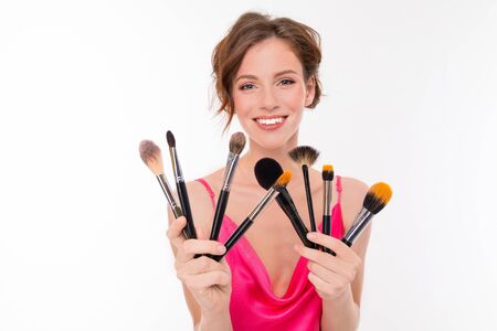 Blogger girl with makeup brushes on white isolatedの写真素材