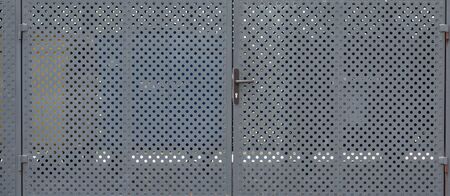 Panorama of metallic gates with round openings