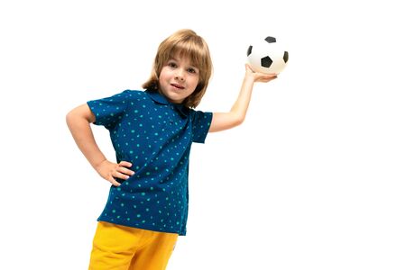 Picture of a teenage caucasian boy holds a soccer ball in one hand isolated on white background.の写真素材