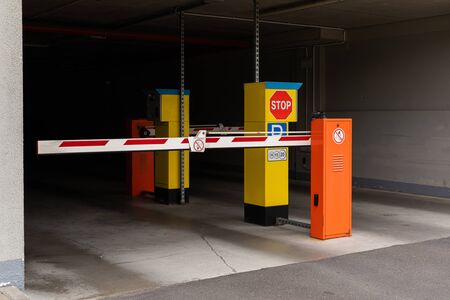 White and red gate arm at modern parking area