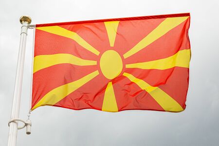 Macedonian flag, on a flagstuff in front of the skyの写真素材