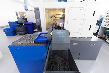 close up shot of screw cutting machine in factory that makes metal detailsの写真素材