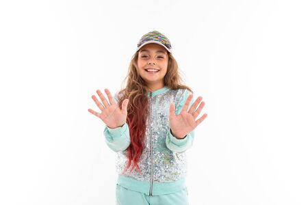 Little pretty caucasian girl in a tracksuit wave hands, picture isolated on white background.