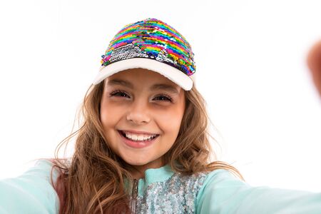 Little pretty caucasian girl in a tracksuit, portrait isolated on white background.