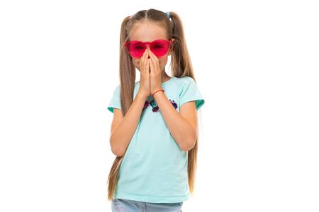 Fashionable teenager girl in blue t-shirt gesticulates, portrait isolated on white background.