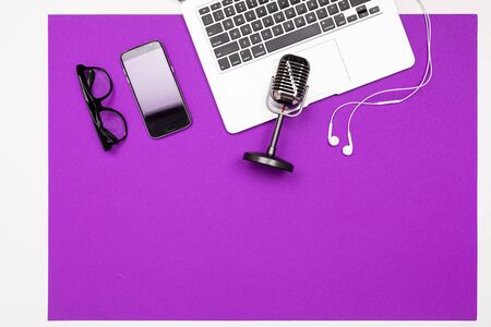 School and office supplies such as note, pens, pencils and other lie neatly on a purple backgroundの写真素材