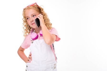 Pretty girl with blonde curly hair, pink glasses call the phone isolated on white background.の写真素材