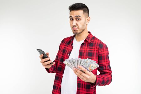 joyful adorable brunette man won the lottery and received a cash prize on a white background with...