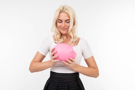 smiling beautiful girl in a white T-shirt and black skirt on a white background with copy space.の写真素材