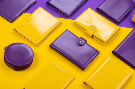 flat lay of bright leather wallets on a matte stylish background.