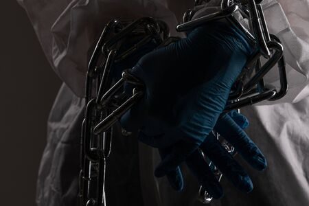 Front liner personnel hand tied with metal chain, coronavirus conceptの写真素材