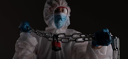 Front liner personnel hand tied with metal chain, coronavirus concept