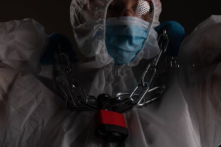 Front liner personnel hand tied with metal chain, coronavirus conceptの写真素材